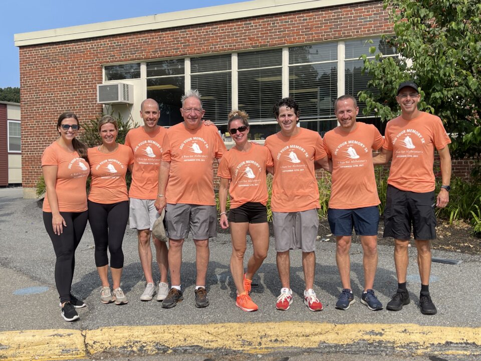 Bob and Jess Rice with members of the Jog Your Memory board in matching race shirts